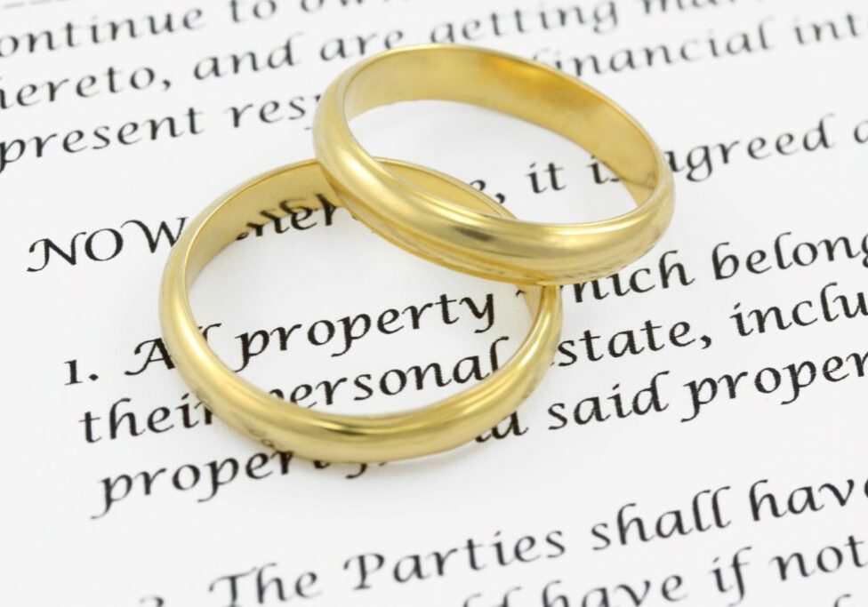 Prenuptial agreement with two wedding rings on top of the document
